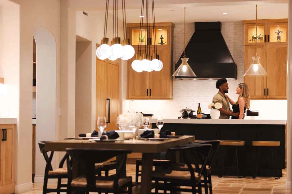 Couple enjoying an evening in a warmly lit kitchen with smart lighting