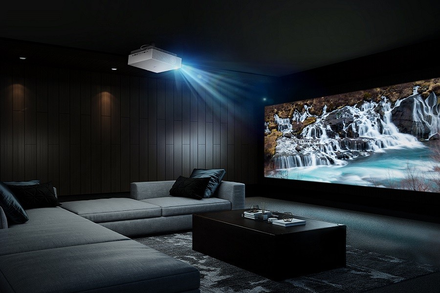 Dramatic home theater installation with a large bright image, elegant decor, and custom seating. 