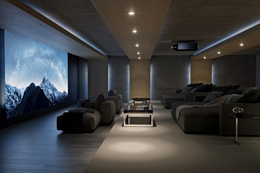 Stunning home theater installation with sophisticated lighting and custom seating with a large, bright image on the screen. 