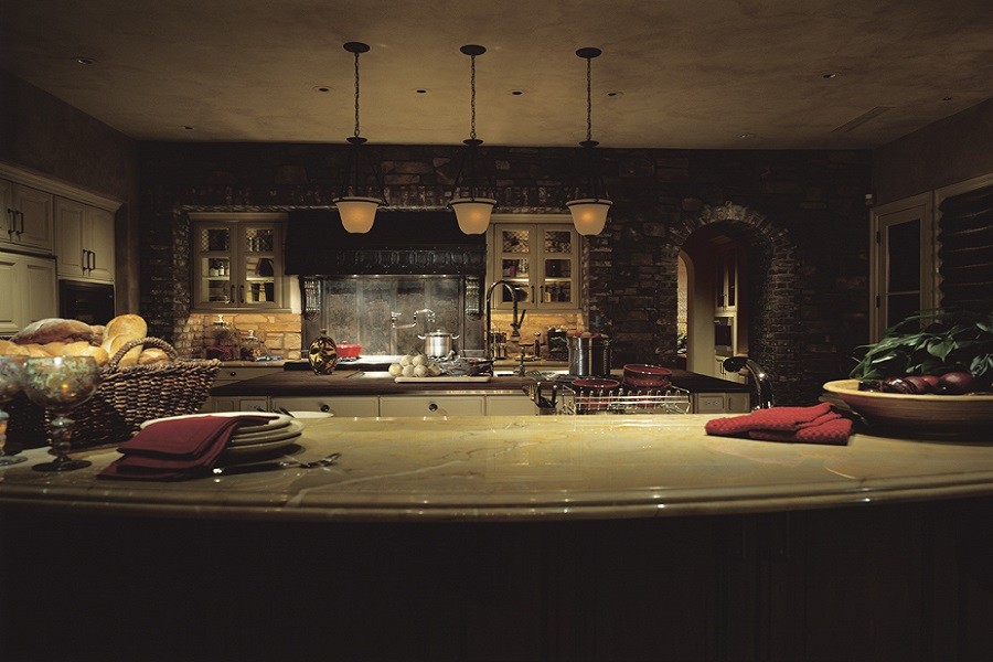 A modern luxury kitchen with sophisticated lighting control adding atmosphere and mood to the occasion. 