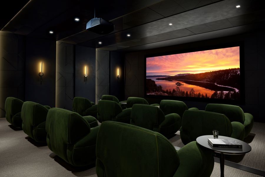 A home theater with a large movie screen, Sony projector, and plush green reclining chairs.