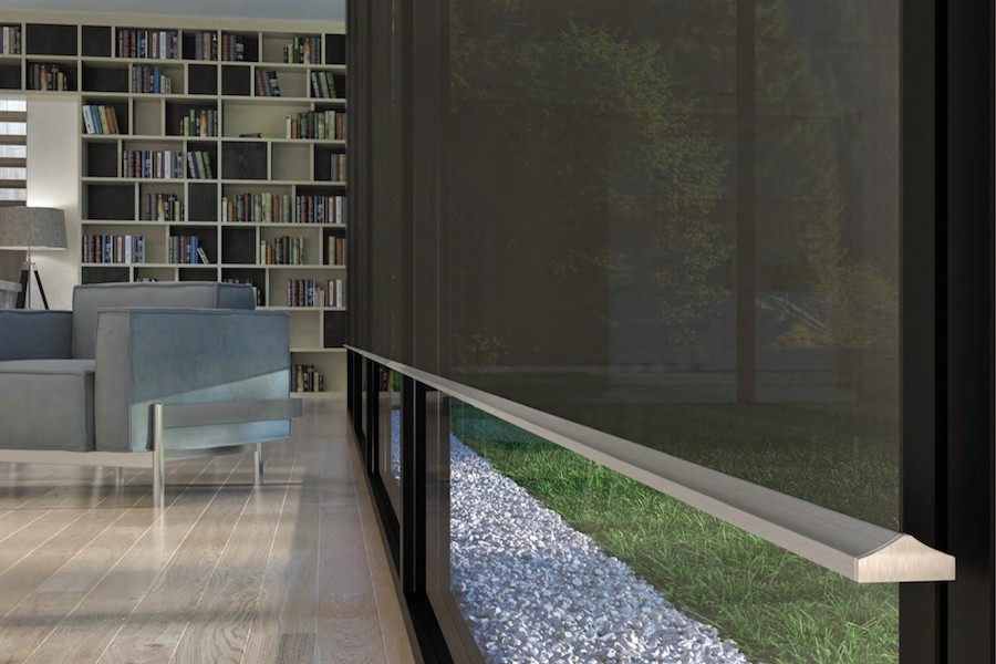 A closeup of a motorized shade in the living area of a modern Denver home. 