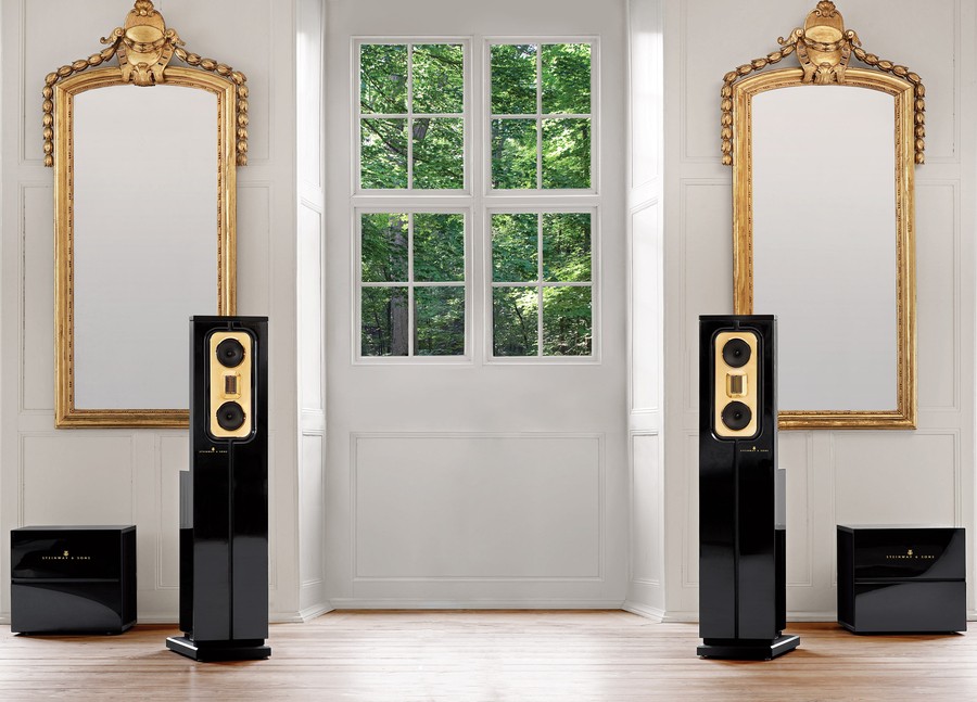 A pair of hi-fi home audio speakers displayed against the backdrop of a Colorado home. 