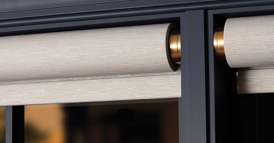 A close-up view of elegant Lutron Palladiom motorized shades discreetly integrated into a window frame.