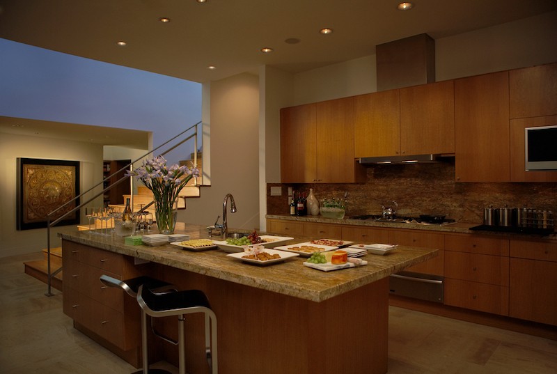 A luxury modern kitchen with soft lighting that sets an evening mood for relaxation and entertaining. 