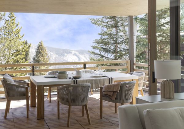 Snowy patio at an Aspen mountain home on a short winter day